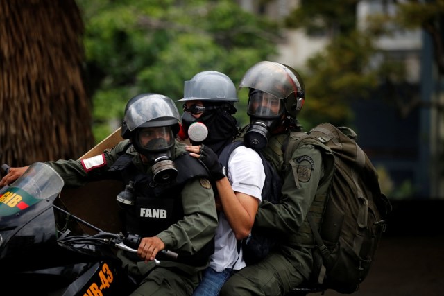 A demonstrator is detained by riot security forces during a protest against Venezuela's President Nicolas Maduro's government in Caracas, Venezuela, May 13, 2017. REUTERS/Carlos Garcia Rawlins