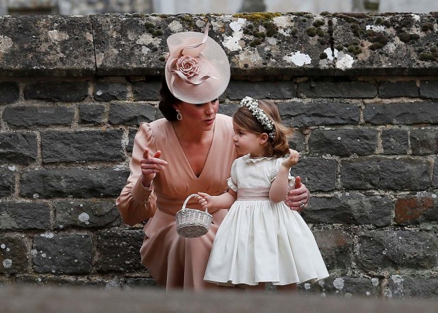 Britain's Catherine, Duchess of Cambridge stands with her daughter Princess Charlotte, a bridesmaid, following the wedding of her sister Pippa Middleton to James Matthews at St Mark's Church in Englefield, west of London, on May 20, 2017. REUTERS/Kirsty Wigglesworth/Pool