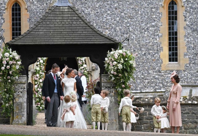 Britain's Catherine, Duchess of Cambridge stands with her children Prince George and Princess Charlotte, following the wedding of her sister Pippa Middleton to James Matthews at St Mark's Church in Englefield, west of London, on May 20, 2017. REUTERS/Justin Tallis/Pool