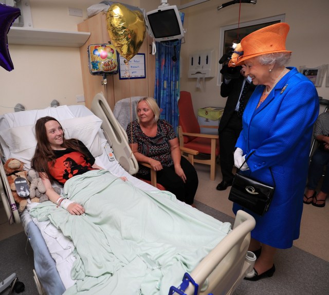 Britain's Queen Elizabeth speaks to Millie Robson, 15, from Co Durham, and her mother, Marie, during a visit to the Royal Manchester Children's Hospital in Manchester, Britain May 25, 2017. REUTERS/Peter Byrne/Pool