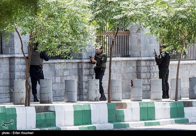 Members of Iranian forces run for cover during an attack on the Iranian parliament in central Tehran, Iran, June 7, 2017. Tasnim News Agency/Handout via REUTERS ATTENTION EDITORS - THIS PICTURE WAS PROVIDED BY A THIRD PARTY. FOR EDITORIAL USE ONLY. NO RESALES. NO ARCHIVE.