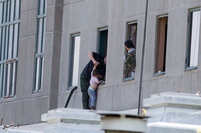 A boy is evacuated during an attack on the Iranian parliament in central Tehran, Iran, June 7, 2017. Tasnim News Agency/Handout via REUTERS ATTENTION EDITORS - THIS PICTURE WAS PROVIDED BY A THIRD PARTY. FOR EDITORIAL USE ONLY. NO RESALES. NO ARCHIVE.
