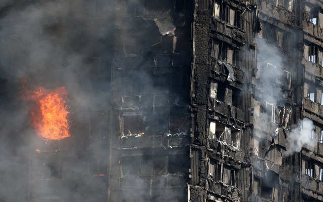 Flames leap from a tower block severly damaged by a serious fire, in north Kensington, West London, Britain June 14, 2017. REUTERS/Neil Hall