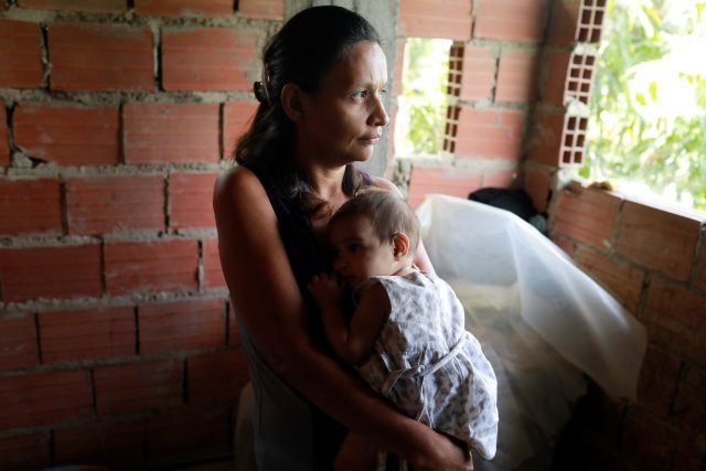 Maryorie Berrios holds Luinyerlin Berrios, who was diagnosed with malnutrition, at her hovel in Caracas, Venezuela June 26, 2017. Picture taken June 26, 2017. REUTERS/Marco Bello