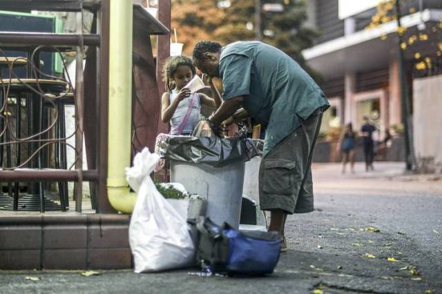 Un hombre y una niña buscan comida en las calles de Caracas, el 21 de febrero DE FOTOS: JUAN BARRETO / AFP / GETTY IMAGES