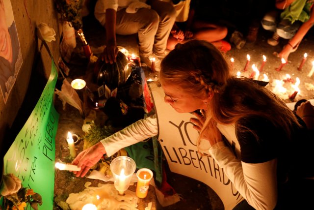 Lilian Tintori, wife of jailed opposition leader Leopoldo Lopez, lights a candle during an event in honor of 17-year-old protester Neomar Lander, the latest fatality from the anti-government unrest and who died during clashes with security forces on Wednesday, in Caracas, Venezuela June 8, 2017. REUTERS/Carlos Garcia Rawlins