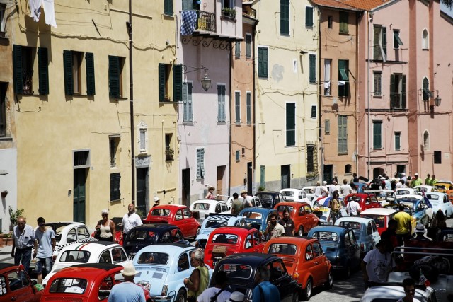 People take part at the 34th International Rally of Fiat 500 Club Italia for the 60th anniversary of this car on July 8, 2017, in Garlenda, near Genoa.   More than 1200 cars came from Europe to take part at the 34 rally of Garlenda to celebrate the 60th anniversary of the Fiat 500.  / AFP PHOTO / Marco BERTORELLO