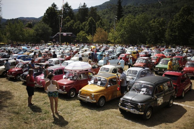 People take part in the 34th International Rally of Fiat 500 Club Italia for the 60th anniversary of this car on July 8, 2017, in Garlenda, near Genoa.   More than 1200 cars came from Europe to take part at the 34 rally of Garlenda to celebrate the 60th anniversary of the Fiat 500.  / AFP PHOTO / Marco BERTORELLO