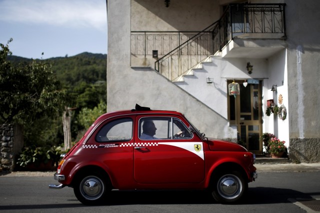 An enthusiast drives past during the 34th International Rally of Fiat 500 Club Italia for the 60th anniversary of this car on July 8, 2017, in Garlenda, near Genoa.   More than 1200 cars came from Europe to take part at the 34 rally of Garlenda to celebrate the 60th anniversary of the Fiat 500.  / AFP PHOTO / Marco BERTORELLO