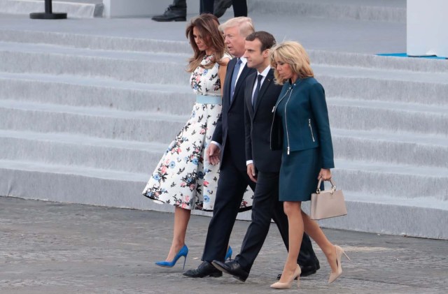(From L) US First Lady Melania Trump, US President Donald Trump, French President Emmanuel Macron and his wife Brigitte Macron leave the tribune after attending the annual Bastille Day military parade on the Champs-Elysees avenue in Paris on July 14, 2017. The parade on Paris's Champs-Elysees will commemorate the centenary of the US entering WWI and will feature horses, helicopters, planes and troops. / AFP PHOTO / joel SAGET