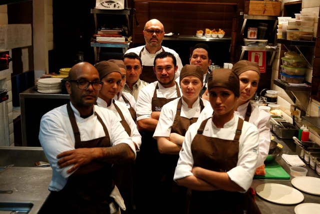 Chef Carlos Garcia (C) and his crew, pose for a picture within the kitchen of the Alto restaurant in Caracas, Venezuela June 29, 2017. Picture taken June 29, 2017. REUTERS/Ivan Alvarado