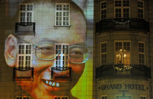 FILE PHOTO: An image of Liu Xiaobo is projected on a hotel in the centre of Oslo following the Nobel Peace Prize ceremony, Norway December 10, 2010. REUTERS/Toby Melville/File Photo     TPX IMAGES OF THE DAY