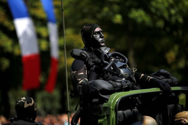 A camouflaged special forces member attends the traditional Bastille day military parade on the Champs-Elysees in Paris, France, July 14, 2017. REUTERS/Stephane Mahe