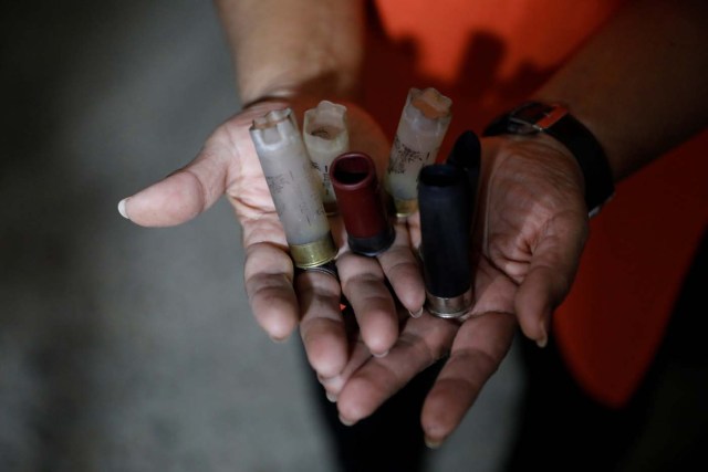 Dilcia Diaz shows cartridges found after a raid of Venezuelan security forces in an apartment complex of Los Teques, Venezuela, July 14, 2017. Picture taken July 14, 2017. REUTERS/Andres Martinez Casares