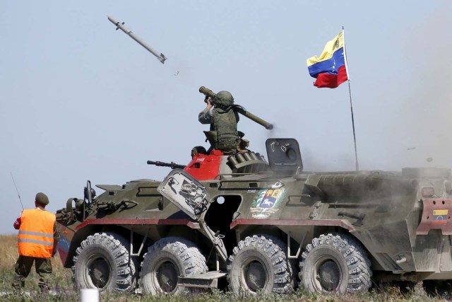 FILE PHOTO: A serviceman from Venezuela fires an anti-aircraft missile with a Russian-made Igla ground-to-air launcher as he sits on top of an armoured personnel carrier (APC) during the Air defense battle masters competition as part of the International Army Games 2015 in the port town of Yeysk, Russia, August 9, 2015. REUTERS/Maxim Zmeyev/Files