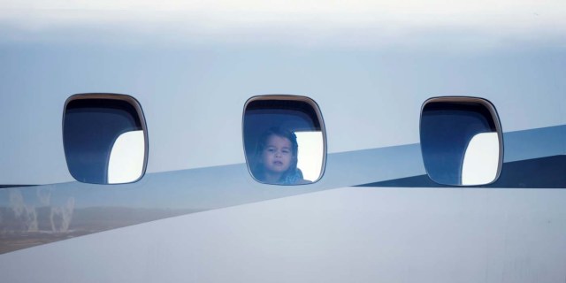 Princess Charlotte, daughter of Britain's Prince William, Duke of Cambridge and his wife Kate, the Duchess of Cambridge peers out of the airplane window upon the arrival at the airport in Berlin on July 19, 2017. REUTERS/Steffi Loos/POOL