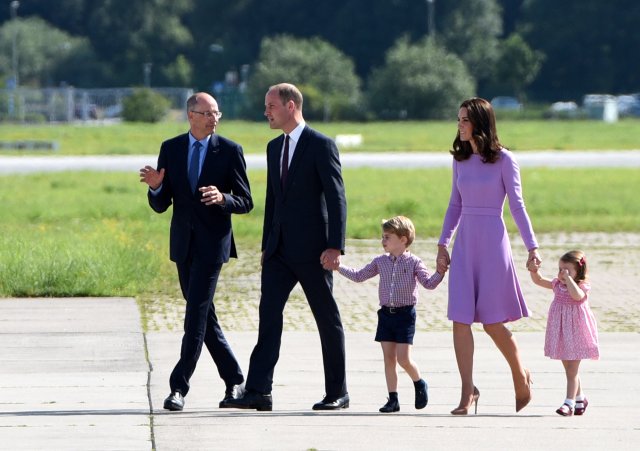 Britain's Prince William, the Duke of Cambridge, his wife Princess Kate, the Duchess of Cambridge, Prince George and Princess Charlotte look at an Airbus helicopter at their plant in Hamburg Finkenwerder, Germany, July 21, 2017 together with CEO Airbus Helicopters Wolfgang Schoder. REUTERS/Daniel Bockwoldt/POOL