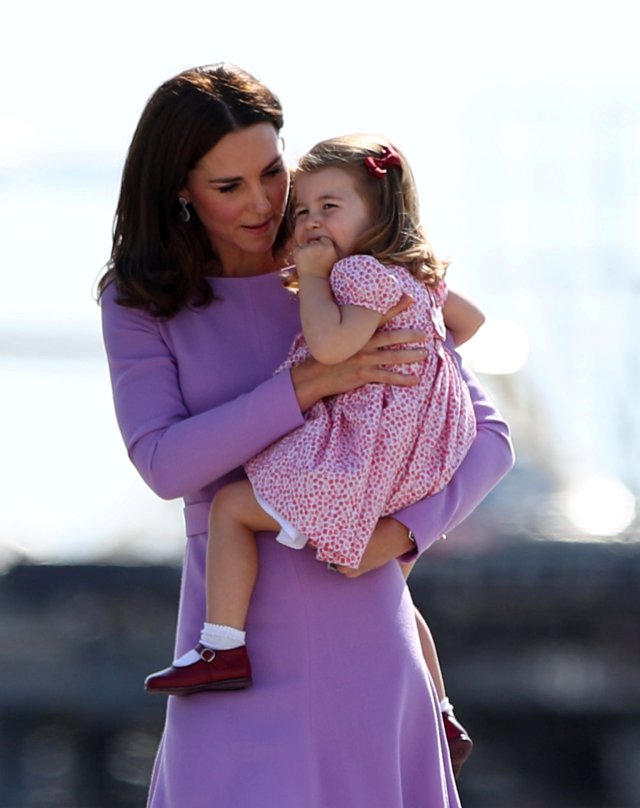 Princess Catherine, the Duchess of Cambridge holds Princess Charlotte before boarding their plane in Hamburg Finkenwerder, Germany, July 21, 2017. REUTERS/Christian Charisius/Pool