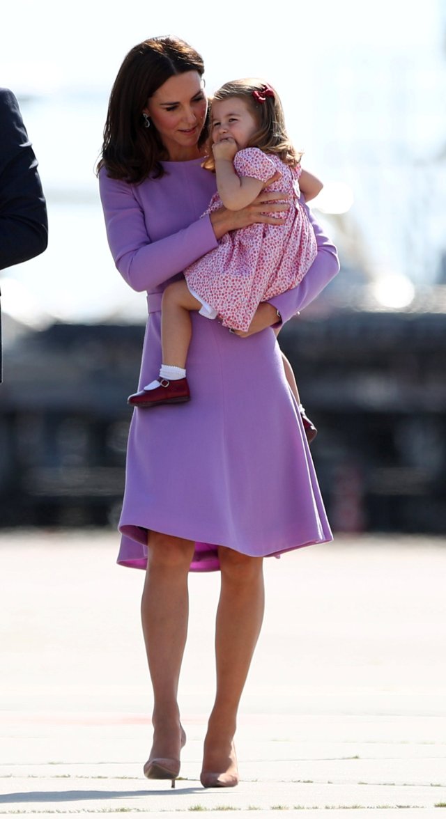 Princess Catherine, the Duchess of Cambridge holds Princess Charlotte before boarding their plane in Hamburg Finkenwerder, Germany, July 21, 2017. REUTERS/Christian Charisius/Pool