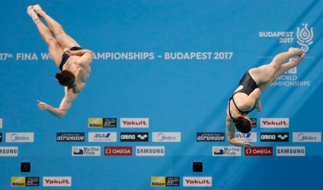 Diving – 17th FINA World Aquatics Championships – Mixed 3m Synchro Springboard Final – Budapest, Hungary – July 22, 2017 – Viktoriya Kesar and Stanislav Oliferchyk of Ukraine compete. REUTERS/David Balogh