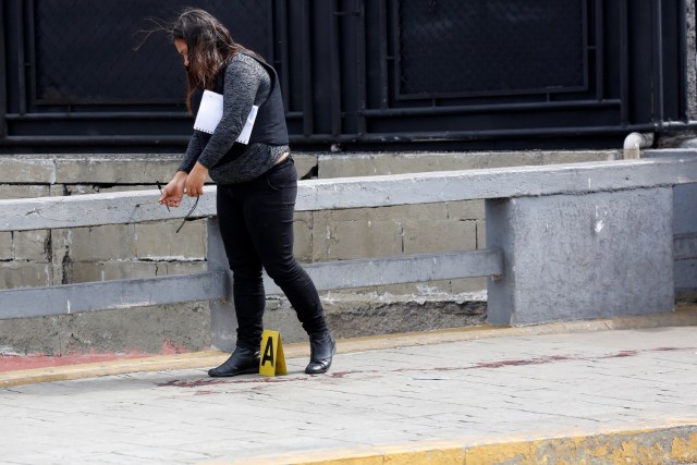 A forensic technician works at a crime scene where, according to the opposition, gunmen "apparently" shot dead and wounded several people during an opposition-organised unofficial plebiscite against President Nicolas Maduro's government and his plan to rewrite the constitution, in Caracas, Venezuela July 16, 2017. REUTERS/Carlos Garcia Rawlins