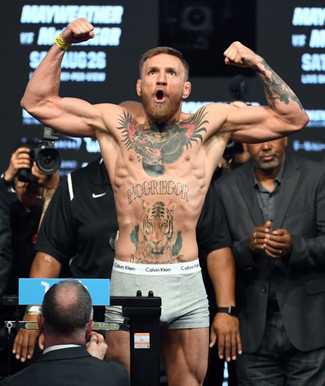 LAS VEGAS, NV - AUGUST 25: UFC lightweight champion Conor McGregor poses on the scale during his official weigh-in at T-Mobile Arena on August 25, 2017 in Las Vegas, Nevada. McGregor will meet boxer Floyd Mayweather Jr. in a super welterweight boxing match at T-Mobile Arena on August 26. Ethan Miller/Getty Images/AFP
