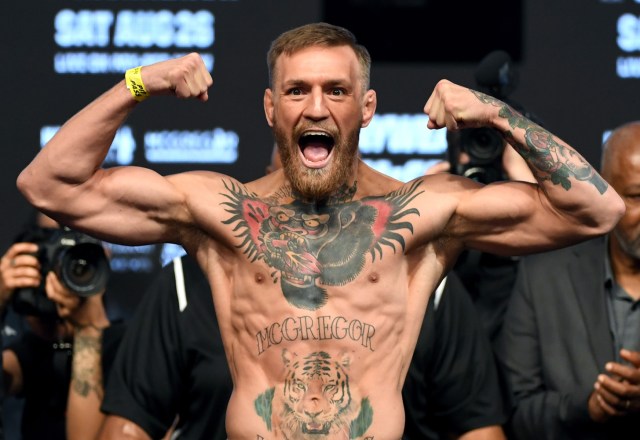 LAS VEGAS, NV - AUGUST 25: UFC lightweight champion Conor McGregor poses on the scale during his official weigh-in at T-Mobile Arena on August 25, 2017 in Las Vegas, Nevada. McGregor will meet boxer Floyd Mayweather Jr. in a super welterweight boxing match at T-Mobile Arena on August 26. Ethan Miller/Getty Images/AFP