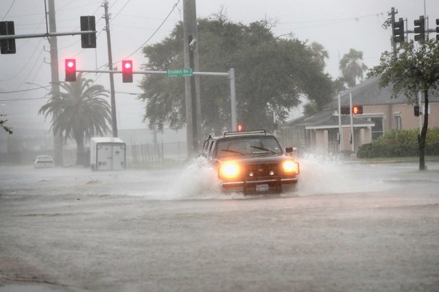 GALVESTON, TX - AUGUST 26: A vehicle navigates a street flooded by rain from Hurricane Harvey on August 26, 2017 in Galveston, Texas. Harvey, which made landfall north of Corpus Christi late last night, is expected to dump upwards to 40 inches of rain in Texas over the next couple of days.   Scott Olson/Getty Images/AFP