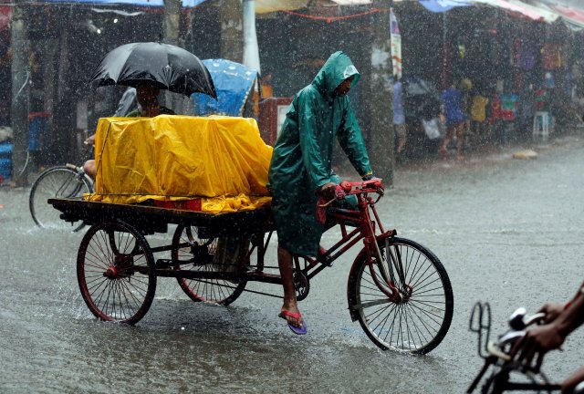 A person drives a van during heavy rain in Dhaka, Bangladesh July 26, 2017. REUTERS/Mohammad Ponir Hossain