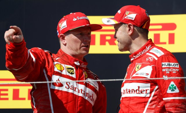Formula One - F1 - Hungarian Grand Prix - Budapest, Hungary - July 30, 2017   Ferrari's Kimi Raikkonen (L) talks with Sebastian Vettel (R)    REUTERS/Laszlo Balogh