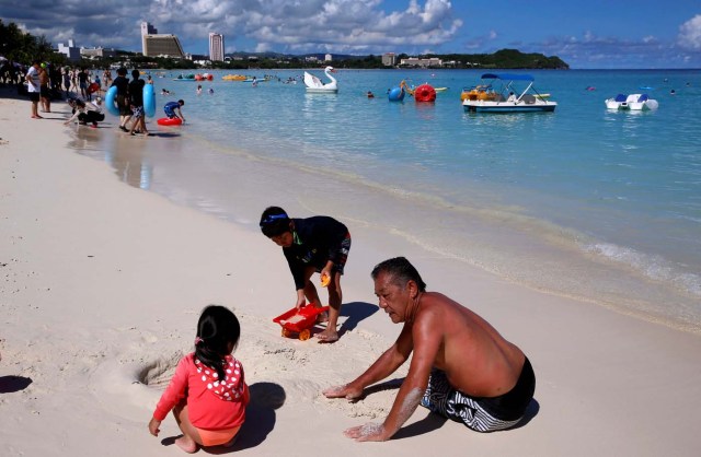 Tourists enjoy the beach in the Tumon tourist district on the island of Guam, a U.S. Pacific Territory, August 12, 2017. REUTERS/Erik De Castro