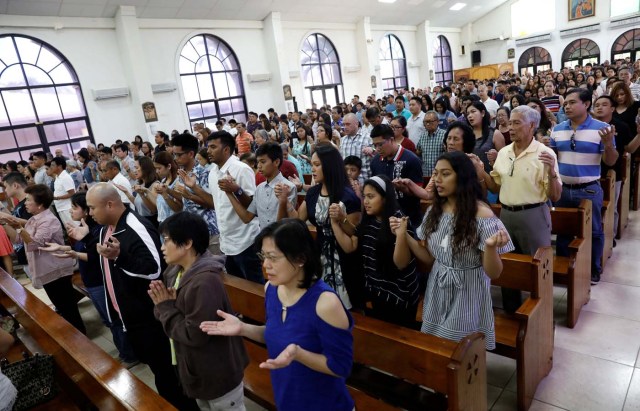 Residents pray during a Sunday mass at Sta Barbara Church on the island of Guam, a U.S. Pacific Territory, August 13, 2017.  REUTERS/Erik De Castro