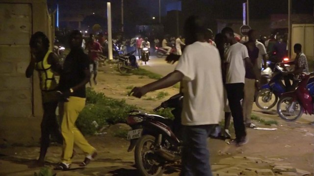 Restaurant customers run in the street following an attack by gunmen on a restaurant in Ouagadougou, Burkina Faso, in this still frame taken from video August 13, 2017. REUTERS/Reuters TV
