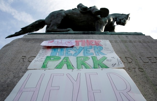 A sign on the statue of Robert E. Lee calls for the park to be renamed for Heather Heyer, who was killed at in a far-right rally, in Charlottesville, Virginia, U.S., August 16, 2017.   REUTERS/Joshua Roberts