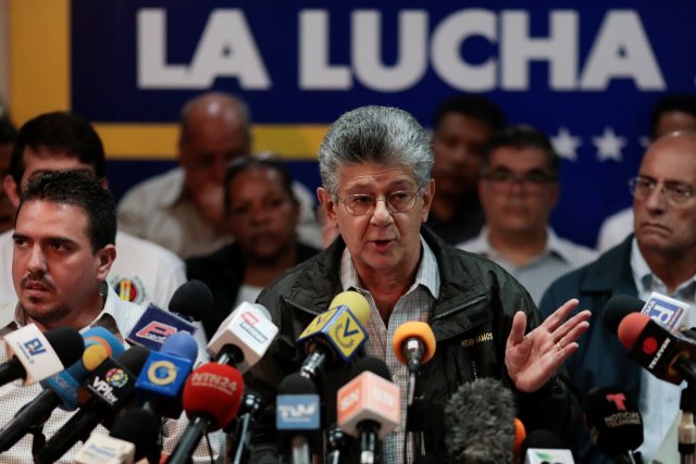 Henry Ramos Allup, lawmaker of the Venezuelan coalition of opposition parties (MUD), talks to the media during a news conference in Caracas, Venezuela August 17, 2017. The billboard in the back reads "The fight". REUTERS/Marco Bello