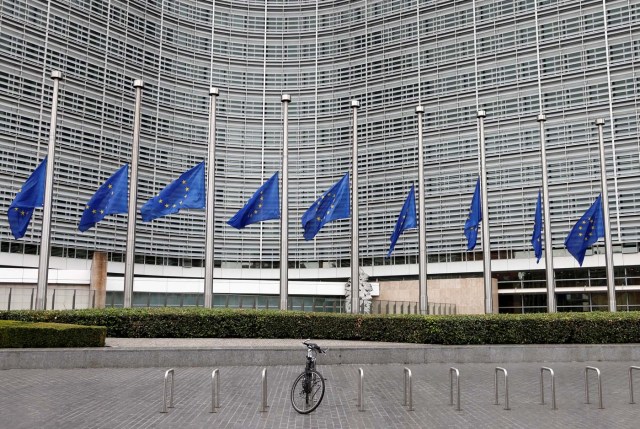 European Union flags are lowered at half-mast in honor of the victims of the Barcelona attack, outside the European Commission headquarters in Brussels, Belgium August 18, 2017. REUTERS/Francois Lenoir