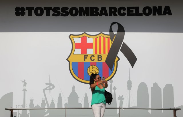 Soccer Football - La Liga - Barcelona vs Real Betis - Barcelona, Spain - August 20, 2017 Fan takes a selfie in front of a wall with a message in reference to the recent attacks in Barcelona REUTERS/Sergio Perez