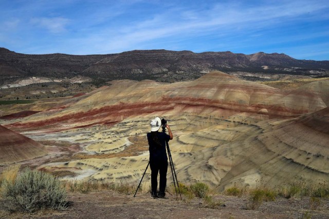 San Francisco Bay area resident Brian Martin photographs Painted Hills, a unit of the John Day Fossil Beds National Monument, in preparation for the total lunar eclipse near Mitchell, Oregon, U.S. August 20, 2017. REUTERS/Adrees Latif