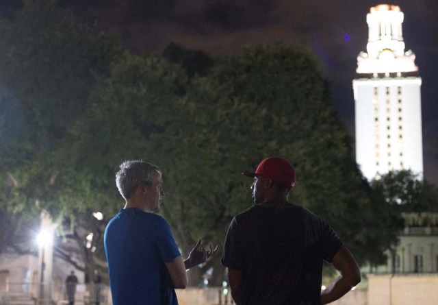 Law student Nathanael Holliday, left, and Mike Lowe, of San Antonio, watch as workers remove Confederate statues from the south mall of the University of Texas in Austin, Texas, U.S., August 21, 2017. REUTERS/Stephen Spillman FOR EDITORIAL USE ONLY. NO RESALES. NO ARCHIVES