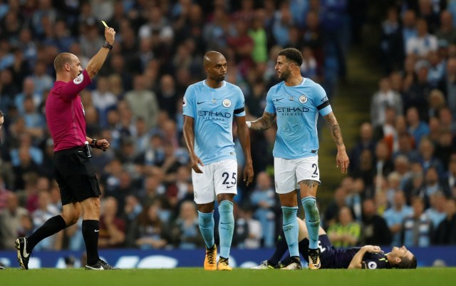 Football Soccer - Premier League - Manchester City vs Everton - Manchester, Britain - August 21, 2017   Manchester City’s Kyle Walker is shown a yellow card by referee Robert Madley for a challenge on Everton's Leighton Baines    Action Images via Reuters/Carl Recine    EDITORIAL USE ONLY. No use with unauthorized audio, video, data, fixture lists, club/league logos or "live" services. Online in-match use limited to 45 images, no video emulation. No use in betting, games or single club/league/player publications. Please contact your account representative for further details.