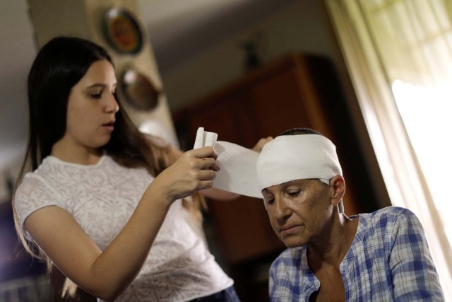  Yolyter Rodríguez, un ama de casa de 56 años y madre de tres, recibe un cuidado de su hija en su residencia en Caracas ( Foto REUTERS/Ueslei Marcelino)