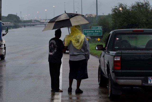 Motorists stranded on Interstate 610 look out over floodwaters after Hurricane Harvey inundated the Texas Gulf coast with rain, in Houston, Texas, U.S. August 27, 2017. REUTERS/Nick Oxford