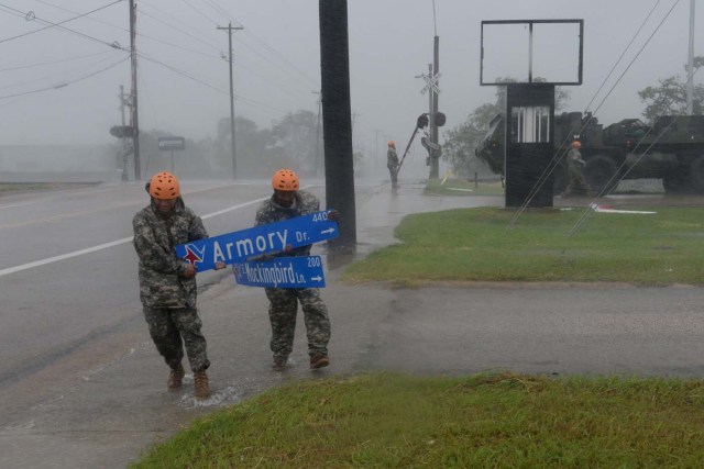 Texas Guardsmen from the 386th Engineer Battalion pick up large debris following Hurricane Harvey in Victoria, Texas, August 26, 2017. Picture taken August 26, 2017. U.S. Army National Guard/Capt. Martha Nigrelle/Handout via REUTERS. ATTENTION EDITORS - THIS IMAGE WAS PROVIDED BY A THIRD PARTY