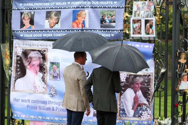 Britain's Prince William, Duke of Cambridge and Prince Harry look at flowers and tributes left in memory of the late Princess Diana at the gates of her former residence Kensington Palace in London, Britain, August 30, 2017. REUTERS/Hannah McKay NO RESALES. NO ARCHIVES