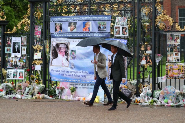 Britain's Prince William, Duke of Cambridge and Prince Harry walk away having taken a look at flowers and tributes left in memory of the late Princess Diana at the gates of her former residence Kensington Palace in London, Britain, August 30, 2017. REUTERS/Hannah McKay NO RESALES. NO ARCHIVES