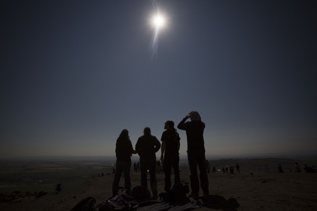MENAN, ID - AUGUST 21: Friends from a nearby college watch the eclipse together on Menan Butte August 21, 2017 in Menan, Idaho. Millions of people have flocked to areas of the U.S. that are in the "path of totality" in order to experience a total solar eclipse. Natalie Behring/Getty Images/AFP