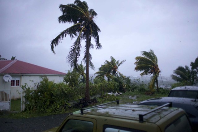 A picture taken on September 19, 2017 shows the powerful winds and rains of hurricane Maria battering the city of Petit-Bourg on the French overseas Caribbean island of Guadeloupe. Hurricane Maria strengthened into a "potentially catastrophic" Category Five storm as it barrelled into eastern Caribbean islands still reeling from Irma, forcing residents to evacuate in powerful winds and lashing rain. / AFP PHOTO / Cedrik-Isham Calvados