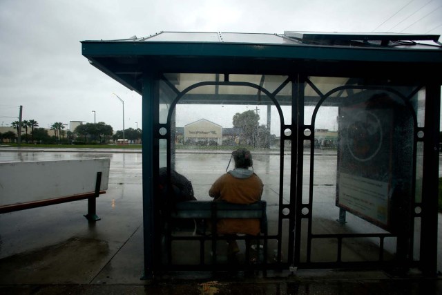 TAMPA, FL - SEPTEMBER 10: With the sky darkening and the wind picking up, people hide from the rain at a bus stop ahead of Hurricane Irma on September 10, 2017 in Tampa, Florida. Hurricane Irma made landfall in the Florida Keys as a Category 4 storm on Sunday, lashing the state with 130 mph winds as it moves up the coast.   Brian Blanco/Getty Images/AFP
