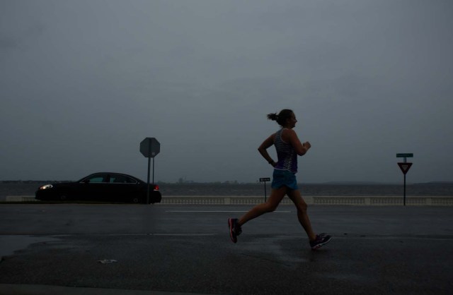 TAMPA, FL - SEPTEMBER 10: With the sky turning dark above her and the wind picking up, a jogger runs on Bayshore Boulevard along Tampa Bay ahead of Hurricane Irma on September 10, 2017 in Tampa, Florida. Hurricane Irma made landfall in the Florida Keys as a Category 4 storm on Sunday, lashing the state with 130 mph winds as it moves up the coast.   Brian Blanco/Getty Images/AFP