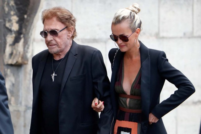 French singer and actor Johnny Hallyday (L) and his wife Laeticia attend the funeral ceremony of late actress Mireille Darc at the Saint-Sulpice church in Paris, France, September 1, 2017. REUTERS/Charles Platiau